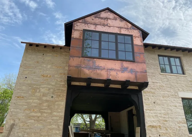 Copper metal panel facade on a stone building for Metal Roof Coating in Fredericksburg